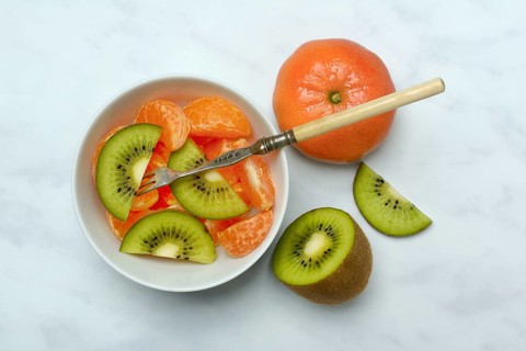 Clementine pieces and kiwi slices in peel