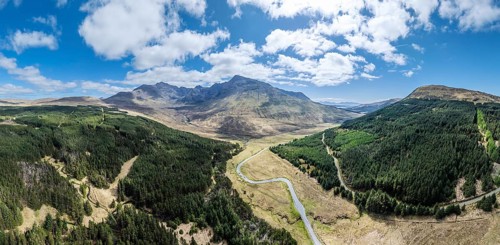 Aerial panoramic drone photo landscape of the Black Cuillins mountain chain with the tourist