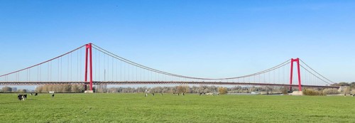 Panorama view over Rhine meadows on the left bank of the Rhine to earth-anchored suspension bridge
