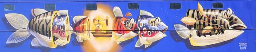 Mural by Stom500 2024, colorful graffiti with series of fish figures, Russian matryoshka, street