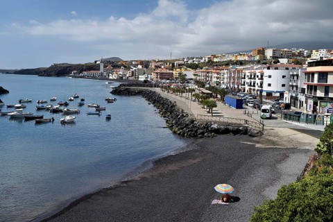 Village view with boat harbour and Basilica de Nuestra Senora de Candelaria, pilgrimage church,