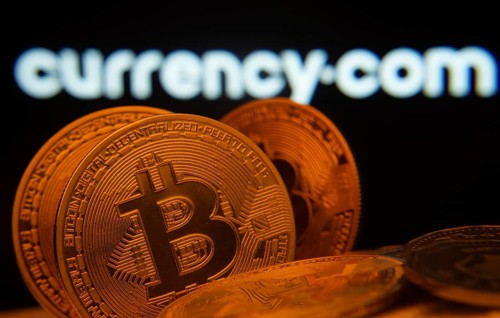 Dhaka, Bangladesh- 22 June 2025: Close-up of Bitcoin coins with the Currency.com logo visible on a