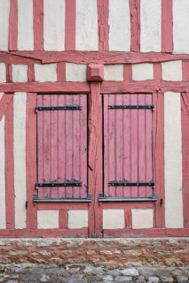 Detailed view of a historic half-timbered house with closed shutters in the old town of Troyes,