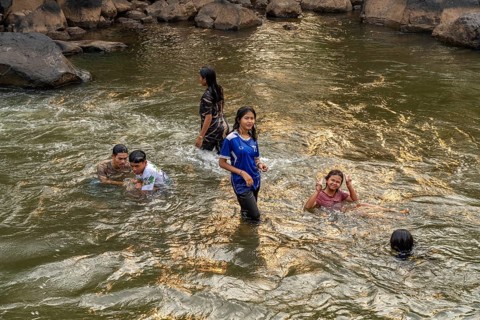 Children bathing in the Tad Lo river, Bolaven Plateau, Laos