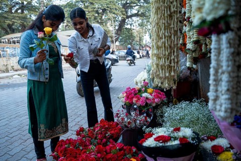 Girls buy roses in a street flower shop, on the occasion of Valentines day on February 14, 2025 in