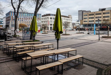 Deserted city centre with closed restaurants and shops due to corona pandemic contact ban,