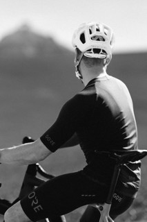 Road bike rider in spring in the Allgäu against the picturesque backdrop of the Alps, Bavaria,