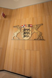 Coat of arms on a wood-clad wall with lion and pegasus motif, state parliament of