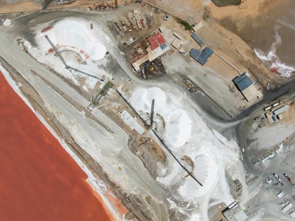 Saline pond and salt heaps at the salt works of Walvis Bay Salt. Aerial view. Drone shot. Walvis