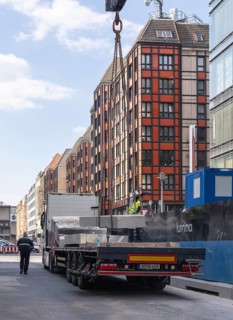 Loading concrete slabs onto a truck trailer using a construction crane, Berlin, Germany