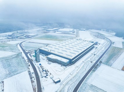 Aerial view of a snow-covered industrial building in a quiet, foggy winter landscape, Nagold, Black