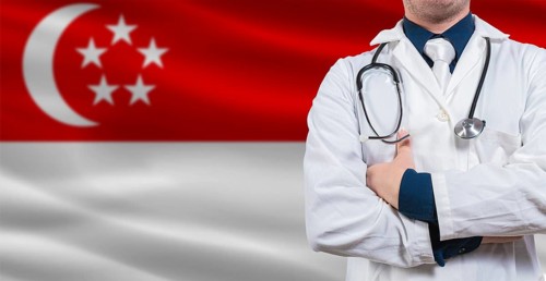 Male doctor with stethoscope on Singapore flag. Doctor holding stethoscope on Singaporean flag