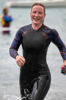 Sportswoman, swimmer comes out of the water after the swimming stage, Tegernsee Triathlon,