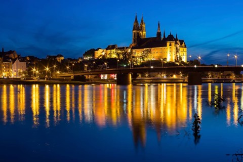 City view with Albrechtsburg castle, cathedral, Elbe river and old Elbe bridge at blue hour,