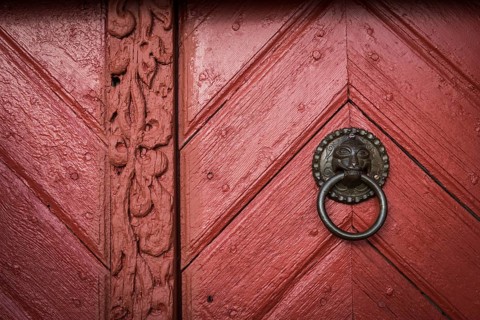Red wooden door, door handle, Skarð á Skarðsströnd vicarage, Dalabyggð, Klofningsnes peninsula,