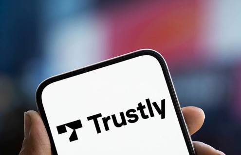 Trustly logo is displayed on smartphone. Trustly AB is a Swedish fintech company