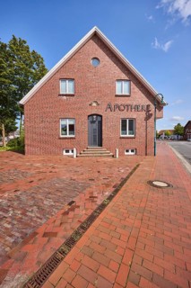Pharmacy, brick building, blue sky with fair weather clouds, Bohlenberger Straße, Zetel, district