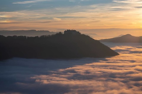 Sunset over the sea of fog from Beurener Fels to Hohenneuffen Castle, Swabian Alb,