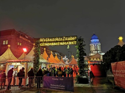 Christmas market on the Gendarmenmarkt at night, festive atmosphere with many visitors, Berlin
