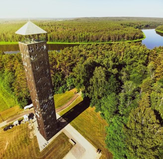 Tourist stand on top look out Birstonas observation tower, highest such tower in Lithuania. Drone