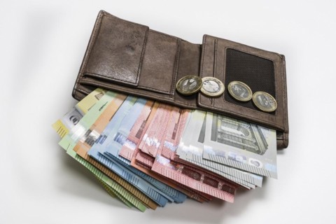 Wallet full of money, symbolic photo income, prices, economy, finances