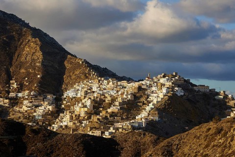 A traditional village lies on a mountain, illuminated by the low sun, Colourful mountain village,