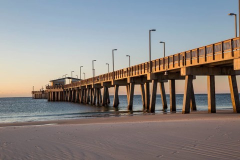 Gulf State Park fishing pier at dawn on the beach of Gulf Shores, Alabama