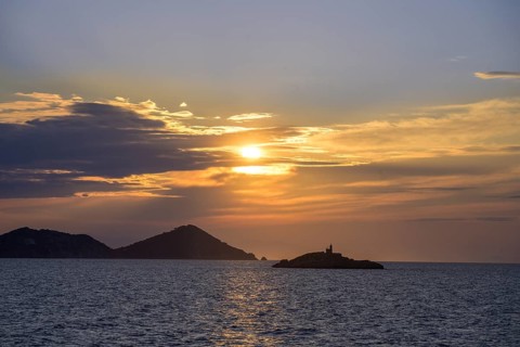 Small lighthouse at sunset on Lo Scoglietto, Arcipelago Toscano, ferry trip to Elba, Livorno