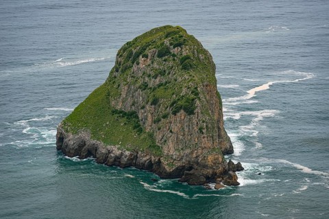 Uninhabited island in the Atlantic off the rocky coast in the Basque Country, Spain