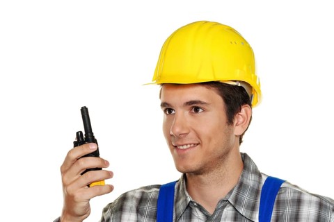 Young craftsman - plumber - construction worker in front of a white background, Austria