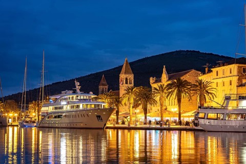 Cruise ships in front of the old town centre of Trogir at dusk, Croatia