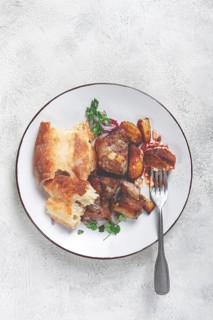 A plate with leftover pork kebab, with bread, on a white plate, close-up, there are no people