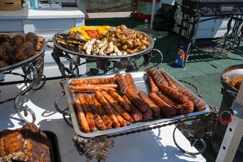 Grilled sausages and meat on a decorative outdoor grill table, Europe Day, Soroca, Republic of