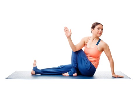 Woman doing yoga asana Ardha matsyendrasana, half spinal twist pose posture isolated on white