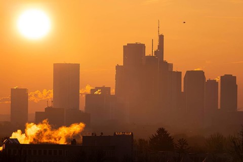 The sun rises behind Frankfurt's banking skyline, Frankfurt am Main, Hesse, Germany