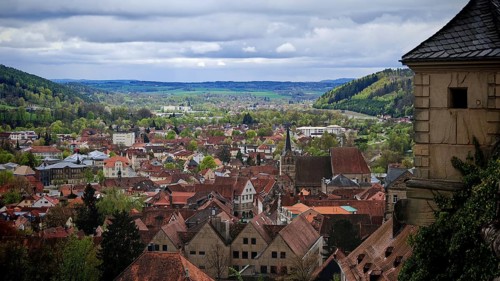 View from the fortress over Kronach with surrounding green hills in spring and cloudy sky, Veste