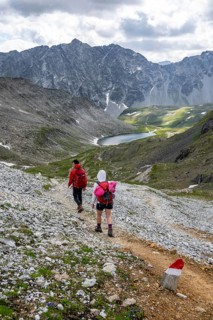 Hikers in front of the Neue Reichenberger Hütte, Hohe Tauern, Austria