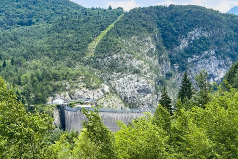 Crown of Vajont dam in front of forest trees grow on site of landslide from Monte Toc disaster