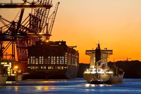 Container ships at the Eurogate container terminal in the evening with an atmospheric sunset,