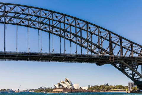 Iconic architectural masterpiece Sydney Opera House with its unique sail-like design on a sunny