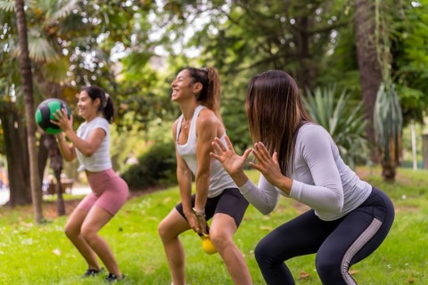 Latin girl doing sports in a green park, lifestyle a healthy life, teacher with the students doing