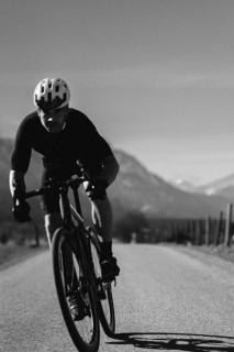 Road bike rider in spring near Halblech in the Allgäu in front of a picturesque backdrop of the
