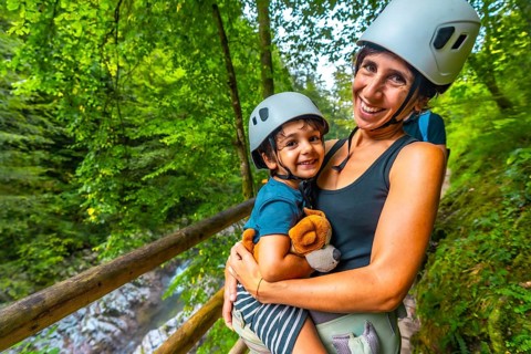 Mother holding her child while enjoying a scenic walk through the beautiful vintgar gorge near