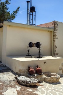Old fountain in front of two clay jugs in Unesco Site Orthodox Greek Orthodox Monastery Moni