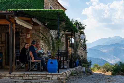 QEPARO FUSHE, ALBANIA - JULY 28, 2026: People sitting at small stone café in Albanian mountains,