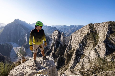 A man takes a moment to rest while practicing mountaineering and rappelling at Eagleâ€™s Nest,