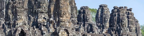 Panoramic image of giant stone-carved faces of the Bodhisattva Lokeshvara, also known as