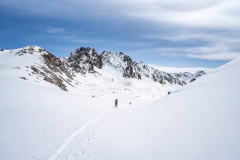 Ski tourer in mountain landscape with snow, ascent to Grialetsch Scharte, Bündner Haute Route,