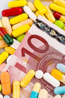 Euro banknotes and tablets, symbolic photo of medication and health insurance costs, Austria