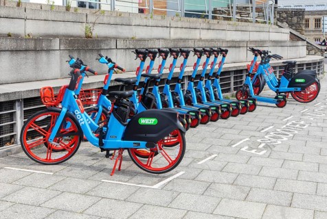 Public rental electric vehicles WEST e-bikes and e-scooters operated by micromobility company Dott,